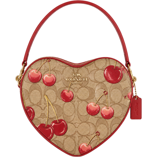 Heart Shaped Coach Purse with Light Brown Coach Logos along with Big Red And Pink Ombré Cherries and A Few Big Red Printed Pattern of Cherries along with a Red Handle