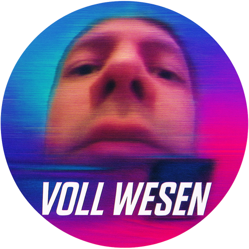 ** * The sticker is **round**, roughly the size of a drink coaster or a large sticker. * The edges are smooth and neatly cut. * The background of the image has **neon gradient colors** — blue, turquoise, purple, and reddish-pink — creating a retro or glitch-style aesthetic. **Central image** * In the center there is a **blurred and heavily zoomed-in face of a person**, photographed from an unusual low angle (from below looking upward). * The face appears slightly **distorted or stretched**, as if the frame was taken from an old digital camera or a low-quality video. * Visible features include: * the eyes near the top, * a large nose in the center, * the lower part of the face (lips and chin) is mostly cut off. * Because of the blur and distortion, the face looks **pixelated and somewhat surreal**. **Image effect** * The picture looks like a **glitched or distorted frame**: * a horizontal line divides the image roughly in the middle; * the lower part looks like **another fragment of the frame**, where a rectangular object can be seen that resembles a phone screen or a small monitor. * On the left side there are **horizontal streaks**, giving the impression of motion or digital distortion. **Text** * In the lower-left part, along the curve of the sticker, it says: **“VOLL WESEN.”** * The font is: * large, * **white**, * elongated and modern, * slightly slanted, similar to typography used in electronic music posters. **Overall impression** * The sticker looks like a **meme or artwork inspired by internet culture, glitch art, or vaporwave aesthetics**. * It gives a sense of **irony or absurd humor** because of the strange facial angle and the digital distortion. 😄 If you want, I can also explain **what “VOLL WESEN” might mean** or what kind of **internet aesthetic or meme style it resembles.**