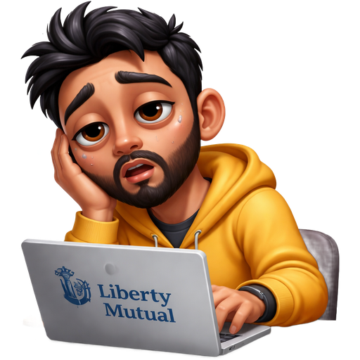 Light brown skin man with black hair and beard working on his computer for Liberty Mutual and he’s exhausted from working