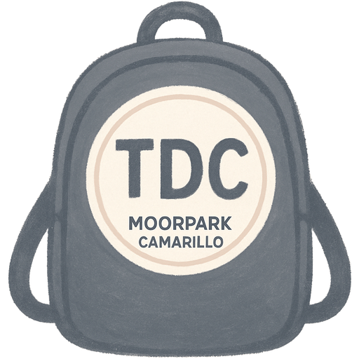 A black backpack that has a white circle outline and in the outline it says TDC. Below TDC it says in small print Moorpark and Camarillo