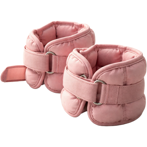A pair of baby pink ankle weights, casually placed on a neutral-toned studio floor, not perfectly aligned—one slightly overlapping the other to create a natural, candid composition. Ultra-realistic studio lighting with soft directional light creates defined yet natural shadows and subtle highlights across the fabric. The material appears textured and slightly worn, with visible stitching, reinforced seams, and Velcro straps partially undone. Fine details include faint lint fibers, tiny creases, pressure indentations, and slight discoloration from use. The weights inside create uneven bulges, adding to realism. Photorealistic rendering with sharp focus, high dynamic range, and true-to-life proportions.