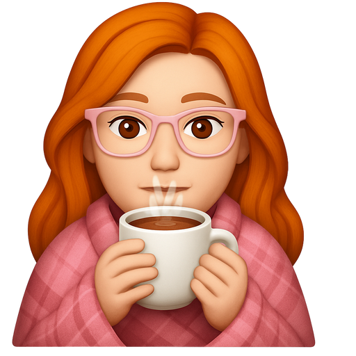 Ginger woman with long hair and light skin and brown eyes shoulders wrapped up in a pink plaid blanket drinking hot chocolate wearing light pink glasses