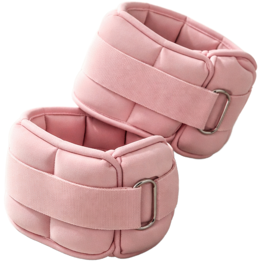 A pair of baby pink ankle weights, casually placed on a neutral-toned studio floor, not perfectly aligned—one slightly overlapping the other to create a natural, candid composition. Ultra-realistic studio lighting with soft directional light creates defined yet natural shadows and subtle highlights across the fabric