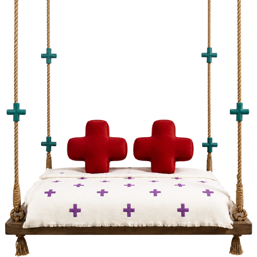 A swing bed with teal crosses on the ropes and blanket with purple crosses on it an red pillows in the shape of a crosses