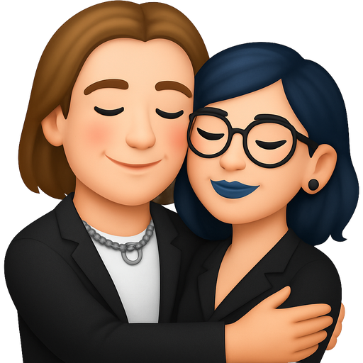 A white man with shoulder length light brown hair (kind of like a bob), dark brown eyebrows, a silver chain with a ring on it around his neck, his cheeks are a little red and he is hugging a girl with shoulder length dark blue hair, round glasses, nose ring and winged eyeliner, she also has a blue lipstick and tunnel piercings in her ears, they are dressed elegant