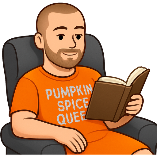 White man with a buzzcut hair and a short beard. Wearing an orange nightgown that says “pumpkin spice queen” in glittery silver letters. Relaxing in a recliner while reading a book